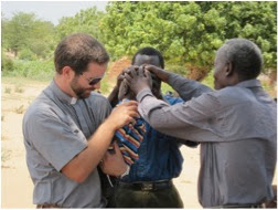 Mbuzi, right, assisting with baptisms in the Nsanje Circuit